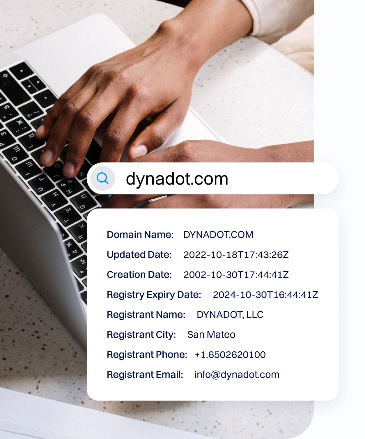 Photo showing hands on a laptop keyboard with a search bar reading “dynadot.com” and a panel displaying domain information such as creation date, expiry date, and registrant details.