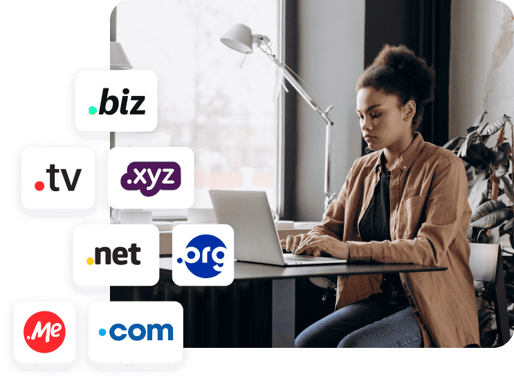 Person working on a laptop at a desk, with floating domain extension icons such as .com, .net, .org, .biz, .xyz, .tv, and .me.
